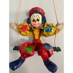 Vintage paper mache clown on swing